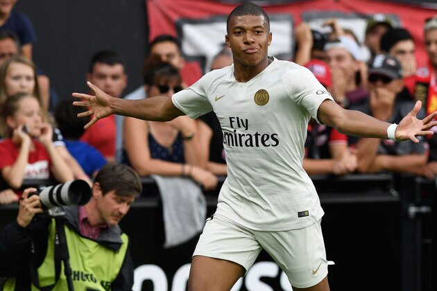 TOPSHOT - Paris Saint-Germain's French forward Kylian Mbappe celebrates after scoring during the French L1 football match between Guingamp and Paris Saint-Germain, at the Roudourou stadium in Guingamp on August 18, 2018. (Photo by FRED TANNEAU / AFP)        (Photo credit should read FRED TANNEAU/AFP/Getty Images)