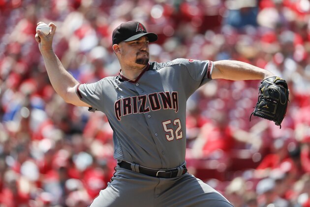 Arizona Diamondbacks starting pitcher Zack Godley throws in the first inning of a baseball game against the Cincinnati Reds, Sunday, Aug. 12, 2018, in Cincinnati. (AP Photo/John Minchillo)