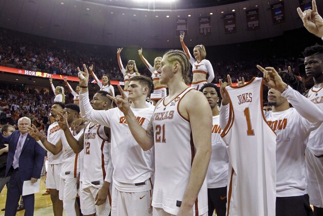 Texas players flash the