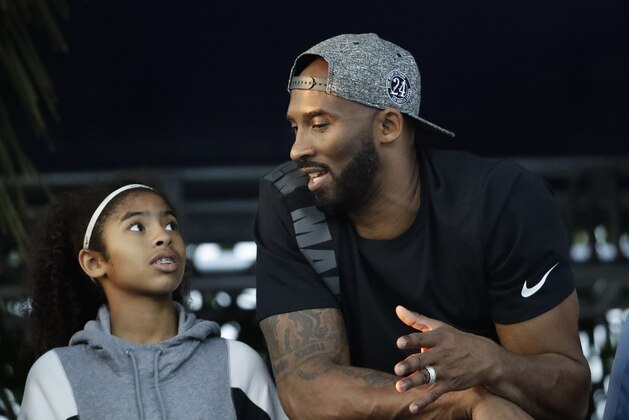 Former Los Angeles Laker Kobe Bryant and his daughter Gianna watch the U.S. national championships swimming meet Thursday, July 26, 2018, in Irvine, Calif. (AP Photo/Chris Carlson)
