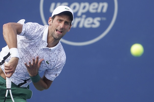 Novak Djokovic, of Serbia, serves to Roger Federer, of Switzerland, during the finals at the Western & Southern Open tennis tournament, Sunday, Aug. 19, 2018, in Mason, Ohio. (AP Photo/John Minchillo)