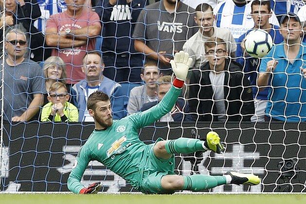 Brighton's Pascal Gross scores his side's third goal from the penalty spot past Manchester United's goalkeeper David de Gea during the English Premier League soccer match between Brighton and Hove Albion and Manchester United at the Amex stadium in Brighton, England, Sunday, Aug. 19, 2018. (AP Photo/Alastair Grant)