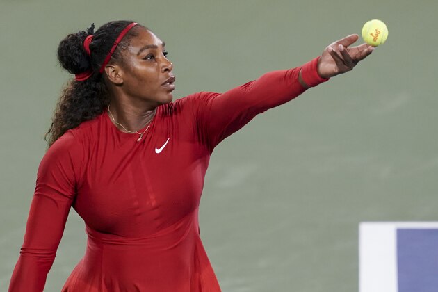 Serena Williams serves to Petra Kvitova, of the Czech Republic, at the Western & Southern Open tennis tournament, Tuesday, Aug. 14, 2018, in Mason, Ohio. (AP Photo/John Minchillo)