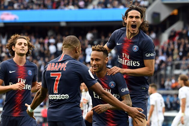 Paris Saint-Germain's Brazilian forward Neymar (2ndR) is congratulated by Paris Saint-Germain's French forward Kylian Mbappe (2ndL) and Paris Saint-Germain's Uruguayan forward Edinson Cavani (R) after scoring a goal during the French L1 football match Paris Saint-Germain (PSG) vs Angers (SCO), on August 25, 2018 at the Parc des Princes in Paris. (Photo by Alain JOCARD / AFP)        (Photo credit should read ALAIN JOCARD/AFP/Getty Images)