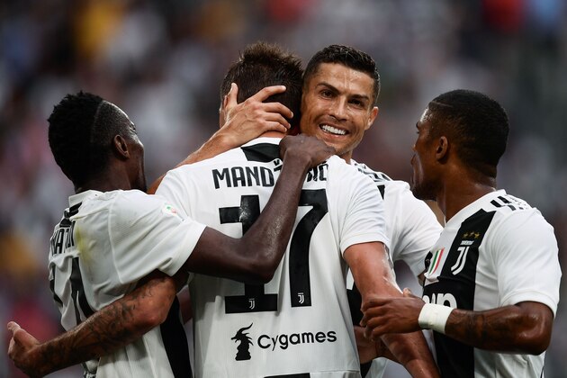 Juventus' Portuguese forward Cristiano Ronaldo (2ndR) and Juventus' French midfielder Blaise Matuidi (L) congratulalte Juventus' Croatian forward Mario Mandzukic after he scored his team's second goal during the Italian Serie A football match Juventus vs Lazio on August 25, 2018 at the Allianz Stadium in Turin. (Photo by Marco BERTORELLO / AFP)        (Photo credit should read MARCO BERTORELLO/AFP/Getty Images)