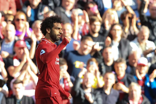 Liverpool's Egyptian midfielder Mohamed Salah celebrates scoring the opening goal during the English Premier League football match between Liverpool and Brighton and Hove Albion at Anfield in Liverpool, north west England on August 25, 2018. (Photo by Lindsey PARNABY / AFP) / RESTRICTED TO EDITORIAL USE. No use with unauthorized audio, video, data, fixture lists, club/league logos or 'live' services. Online in-match use limited to 120 images. An additional 40 images may be used in extra time. No video emulation. Social media in-match use limited to 120 images. An additional 40 images may be used in extra time. No use in betting publications, games or single club/league/player publications. /         (Photo credit should read LINDSEY PARNABY/AFP/Getty Images)