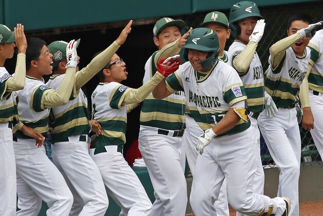 South Korea's Ji Hying Choi (17) celebrates with teammates as he returns to the dugout after hitting a solo home run off Japan's Shisei Fujimoto in the first inning of the International Championship baseball game at the Little League World Series tournament, Saturday, Aug. 25, 2018, in South Williamsport, Pa. (AP Photo/Tom E. Puskar)