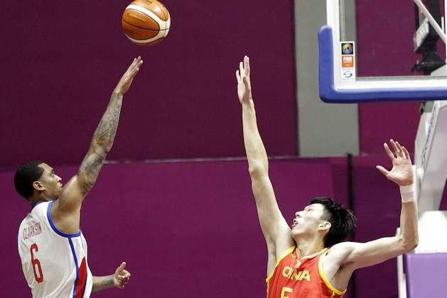 Philippines' Jordan Clarkson takes a shot at the basket as China's Shuo Fang attempts to block during their men's basketball game at the 18th Asian Games in Jakarta, Indonesia on Tuesday, Aug. 21, 2018. (AP Photo/Aaron Favila)