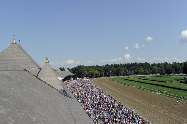 Race fans watch the second race prior to the Travers Stakes horse race at Saratoga Race Course in Saratoga Springs, N.Y., Saturday, Aug. 27, 2016.  (AP Photo/Hans Pennink)