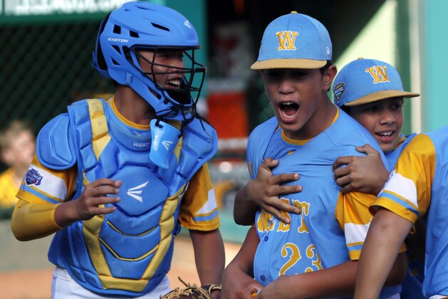 Honolulu, Hawaii's Aukai Kea (23) celebrates with catcher Bruce Boucher, left, and Taylin Oana after getting the final out of the United States Championship baseball game against Peachtree City, Georgia at the Little League World Series tournament in South Williamsport, Pa., Saturday, Aug. 25, 2018. Hawaii won 3-0 and will face South Korea in the Little League World Series Championship game Sunday. (AP Photo/Tom E. Puskar)