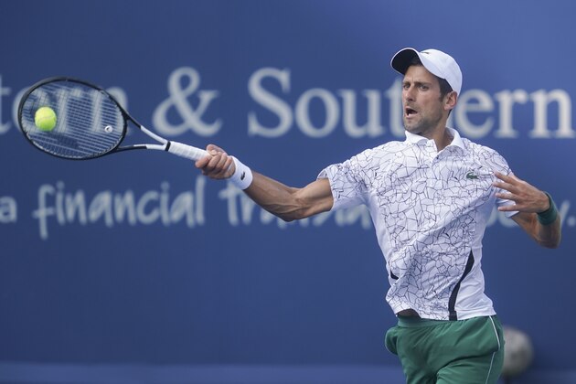 Novak Djokovic, of Serbia, returns to Roger Federer, of Switzerland, during the finals at the Western & Southern Open tennis tournament, Sunday, Aug. 19, 2018, in Mason, Ohio. (AP Photo/John Minchillo)