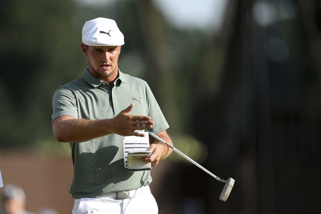 Bryson DeChambeau looks at his putt on the green at the 18th hole during the third round of the Northern Trust golf tournament, Saturday, Aug. 25, 2018, in Paramus, N.J. (AP Photo/Mel Evans)
