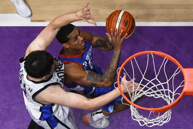 Philippines' Jordan Clarkson (top) goes for the basket against South Korea in the men's basketball quarter-final match between South Korea and the Philippines during the 2018 Asian Games in Jakarta on August 27, 2018. (Photo by Lillian SUWANRUMPHA / AFP)        (Photo credit should read LILLIAN SUWANRUMPHA/AFP/Getty Images)