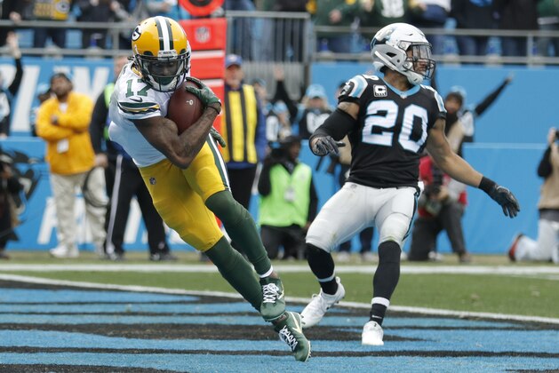 Green Bay Packers' Davante Adams (17) catches a touchdown pass against Carolina Panthers' Kurt Coleman (20) during the first half of an NFL football game in Charlotte, N.C., Sunday, Dec. 17, 2017. (AP Photo/Bob Leverone)