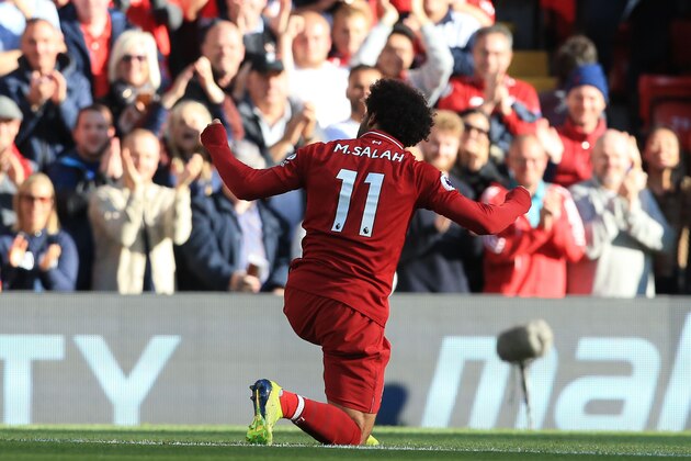 Liverpool's Egyptian midfielder Mohamed Salah celebrates scoring the opening goal during the English Premier League football match between Liverpool and Brighton and Hove Albion at Anfield in Liverpool, north west England on August 25, 2018. (Photo by Lindsey PARNABY / AFP) / RESTRICTED TO EDITORIAL USE. No use with unauthorized audio, video, data, fixture lists, club/league logos or 'live' services. Online in-match use limited to 120 images. An additional 40 images may be used in extra time. No video emulation. Social media in-match use limited to 120 images. An additional 40 images may be used in extra time. No use in betting publications, games or single club/league/player publications. /         (Photo credit should read LINDSEY PARNABY/AFP/Getty Images)