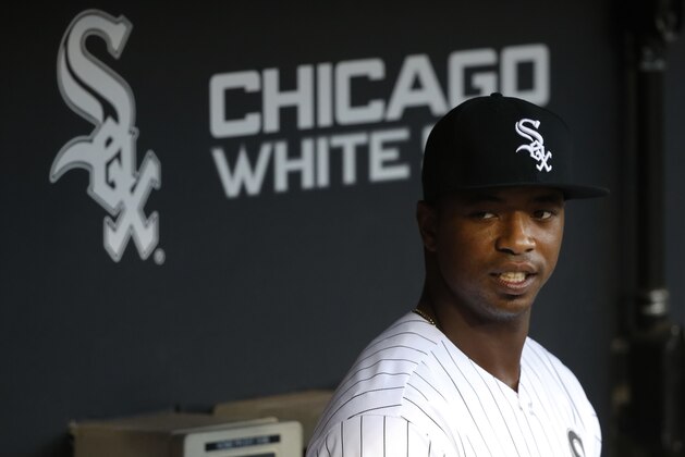 Eloy Jimenez, an outfielder with the Birmingham Barons, a Double-A affiliate of the Chicago White Sox, stands in the dugout before throwing out a ceremonial first pitch before a baseball game between the White Sox and the Cleveland Indians Tuesday, Sept. 5, 2017, in Chicago. (AP Photo/Charles Rex Arbogast)