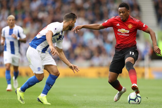 BRIGHTON, ENGLAND - AUGUST 19:  Martin Montoya of Brighton and Hove Albion and Anthony Martial of Manchester United battle for the ball during the Premier League match between Brighton & Hove Albion and Manchester United at American Express Community Stadium on August 19, 2018 in Brighton, United Kingdom.  (Photo by Dan Istitene/Getty Images)
