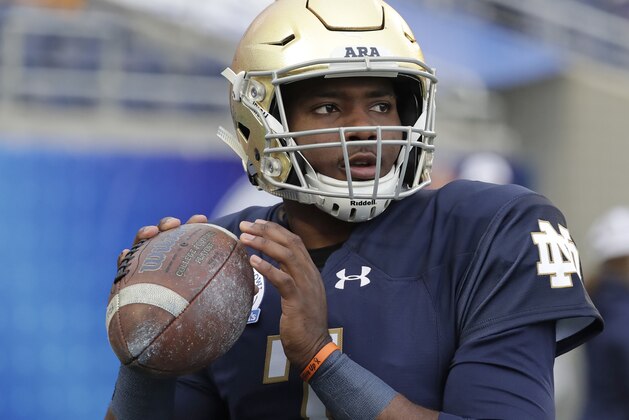 Notre Dame quarterback Brandon Wimbush (7) looks for a receiver as he warms up before the Citrus Bowl NCAA college football game against LSU, Monday, Jan. 1, 2018, in Orlando, Fla. (AP Photo/John Raoux)