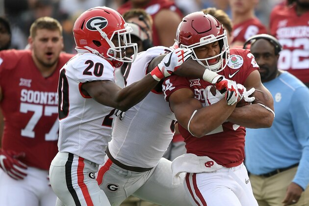 PASADENA, CA - JANUARY 01:  Running back Rodney Anderson #24 of the Oklahoma Sooners runs the ball against defensive back J.R. Reed #20 of the Georgia Bulldogs in the first half in the 2018 College Football Playoff Semifinal at the Rose Bowl Game presented by Northwestern Mutual at the Rose Bowl on January 1, 2018 in Pasadena, California.  (Photo by Kevork Djansezian/Getty Images)
