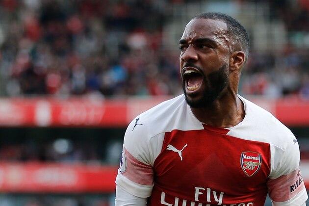 Arsenal's French striker Alexandre Lacazette celebrates their second goal after his cross was turned in for an own goal during the English Premier League football match between Arsenal and West Ham United at the Emirates Stadium in London on August 25, 2018. (Photo by Ian KINGTON / AFP) / RESTRICTED TO EDITORIAL USE. No use with unauthorized audio, video, data, fixture lists, club/league logos or 'live' services. Online in-match use limited to 120 images. An additional 40 images may be used in extra time. No video emulation. Social media in-match use limited to 120 images. An additional 40 images may be used in extra time. No use in betting publications, games or single club/league/player publications. /         (Photo credit should read IAN KINGTON/AFP/Getty Images)