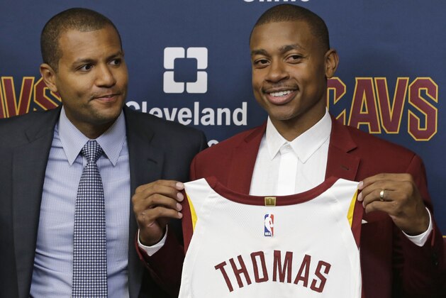 Cleveland Cavaliers' Isaiah Thomas, right, holds up his jersey as general manager Koby Altman looks on during a news conference at the NBA basketball teams practice facility, Thursday, Sept. 7, 2017, in Independence, Ohio. (AP Photo/Tony Dejak)