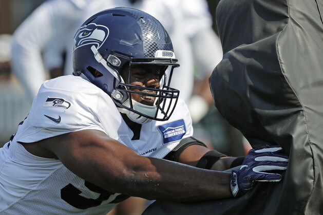 Seattle Seahawks defensive end Rasheem Green hits a blocking sled during NFL football training camp, Sunday, July 29, 2018, in Renton, Wash. (AP Photo/Ted S. Warren)