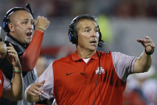 FILE - In this Sept. 17, 2016, file photo, Ohio State head coach Urban Meyer, right, and then-assistant coach Zach Smith, left, gesture from the sidelines during an NCAA college football game against Oklahoma in Norman, Okla. What has transpired over the last three weeks at Ohio State should be a lesson to all coaches. Your football program is not a family. Urban Meyer treated Zach Smith like family, and it almost cost one of the most accomplished coaches in college football his job. (AP Photo/Sue Ogrocki, File)