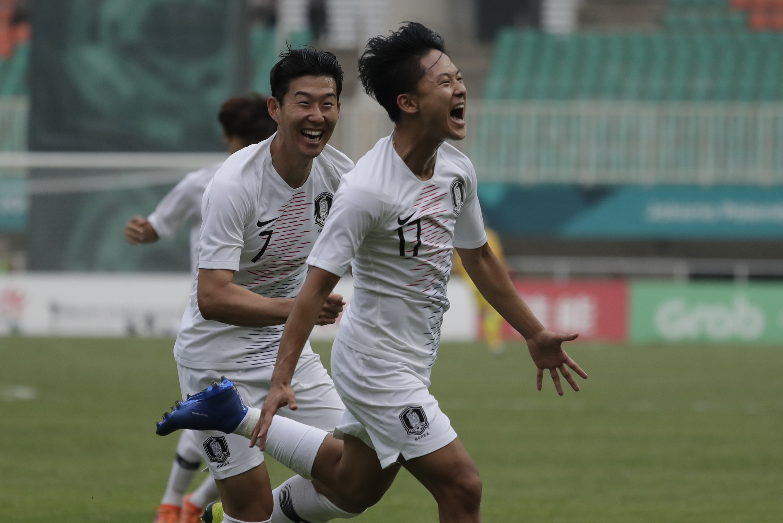 South Korea's Lee Seung-woo celebrates his goal with teammate Son Heung-min after scoring during their men's semifinal soccer match against Vietnam at the 18th Asian Games in Bogor, West Java, Indonesia, Wednesday, Aug. 29, 2018. (AP Photo/Lee Jin-man)