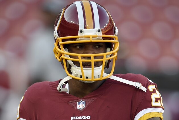 Washington Redskins running back Adrian Peterson warms up before a preseason NFL football game against the Denver Broncos, Friday, Aug. 24, 2018, in Landover, Md. (AP Photo/Nick Wass)