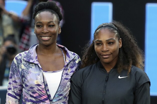 FILE - In this Jan. 28, 2017, file photo, Venus, left, and Serena Williams pose ahead of the women's singles final at the Australian Open tennis championships in Melbourne, Australia. Serena Williams was one of the first major athletes to decry the failure to indict a white officer in the death of unarmed black teenager Michael Brown in Ferguson, Missouri _ while also condemning violence against police. Williams’ older sister, Venus, who has advocated for equal pay for professional tennis while winning seven Grand Slam titles, believes it is important to have a voice on these issues. (AP Photo/Aaron Favila, File)
