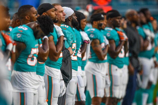 MIAMI, FL - AUGUST 25: Miami Dolphins during the National Anthem before a preseason game between the Miami Dolphins and the Baltimore Ravens at Hard Rock Stadium on August 25, 2018 in Miami, Florida. (Photo by Mark Brown/Getty Images)