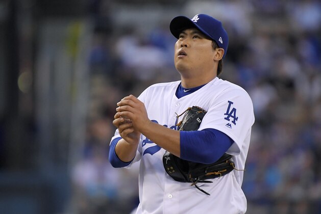 Los Angeles Dodgers starting pitcher Hyun-Jin Ryu rubs up the ball before pitching during the first inning of the team's baseball game against the San Francisco Giants on Wednesday, Aug. 15, 2018, in Los Angeles. (AP Photo/Mark J. Terrill)