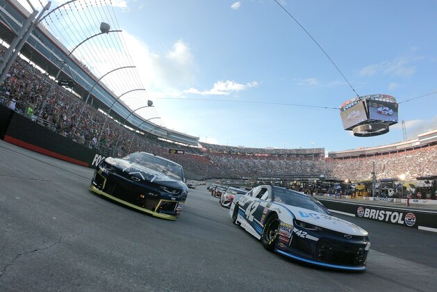 BRISTOL, TN - AUGUST 18:  Kyle Larson, driver of the #42 DC Solar Chevrolet, and Chase Elliott, driver of the #9 Kelley Blue Book Chevrolet, take a pace lap prior to the start of the Monster Energy NASCAR Cup Series Bass Pro Shops NRA Night Race at Bristol Motor Speedway on August 18, 2018 in Bristol, Tennessee.  (Photo by Matt Sullivan/Getty Images)