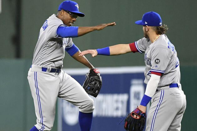 Toronto Blue Jays' Curtis Granderson, left, and Josh Donaldson celebrate the team's 8-5 victory over the Texas Rangers in a baseball game Friday, April 6, 2018, in Arlington, Texas. (AP Photo/Jeffrey McWhorter)