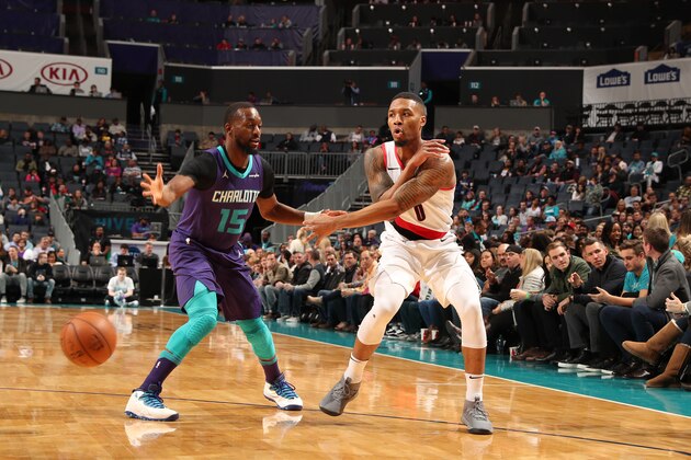 CHARLOTTE, NC - DECEMBER 16:  Damian Lillard #0 of the Portland Trail Blazers passes the ball against Kemba Walker #15 of the Charlotte Hornets on December 16, 2017 at Spectrum Center in Charlotte, North Carolina. NOTE TO USER: User expressly acknowledges and agrees that, by downloading and or using this photograph, User is consenting to the terms and conditions of the Getty Images License Agreement.  Mandatory Copyright Notice:  Copyright 2017 NBAE (Photo by Kent Smith/NBAE via Getty Images)