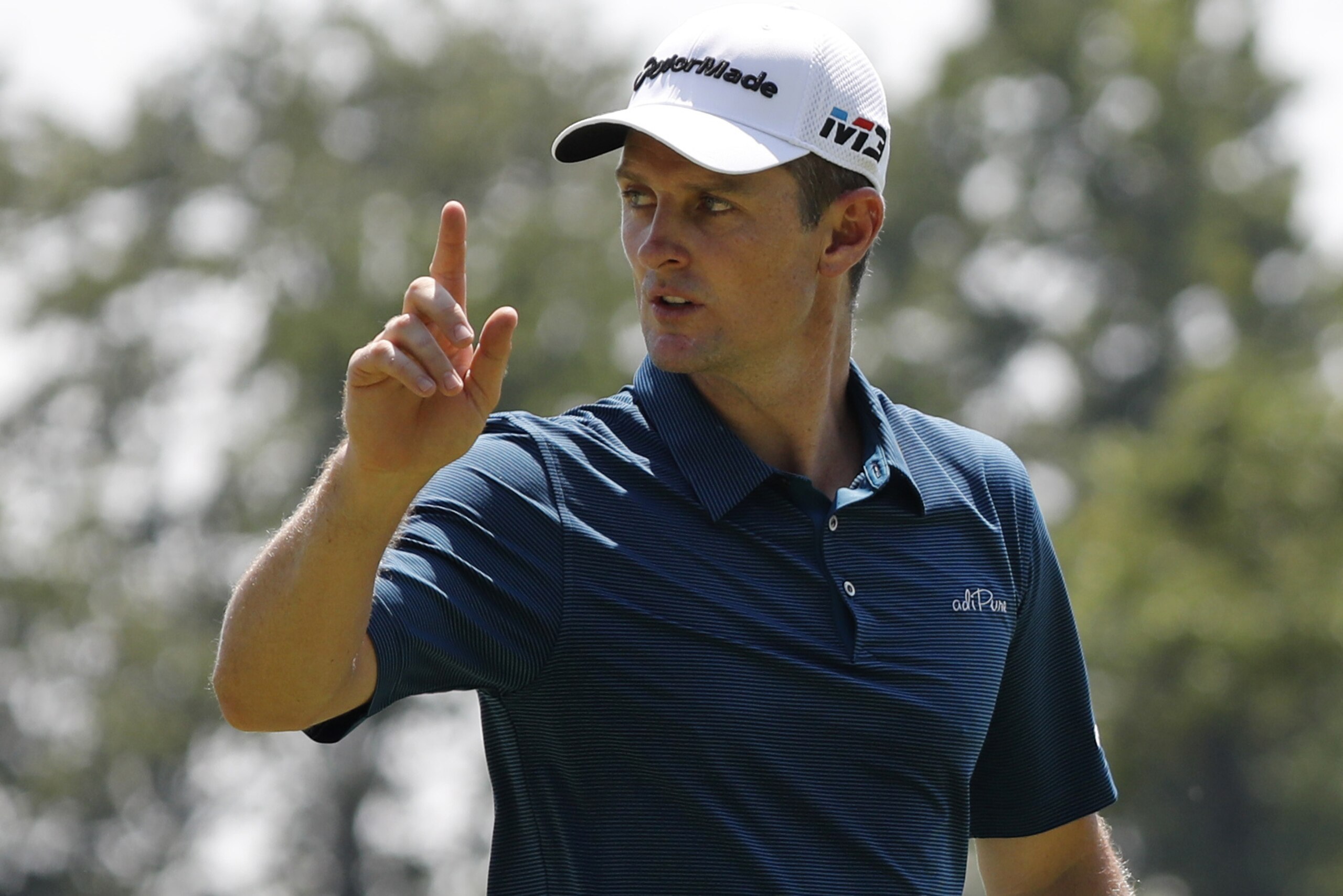 Justin Rose, of England, reacts after making a putt on the first green during the third round of the PGA Championship golf tournament at Bellerive Country Club, Saturday, Aug. 11, 2018, in St. Louis. (AP Photo/Brynn Anderson)