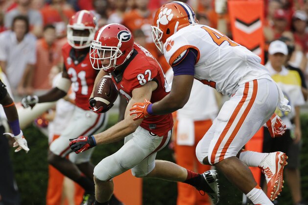 Georgia wide receiver Michael Bennett (82) runs the ball after making a catch past the defense of Clemson linebacker B.J. Goodson, right, in the first half of an NCAA college football game, Saturday, Aug. 30, 2014, in Athens, Ga. (AP Photo/David Goldman)