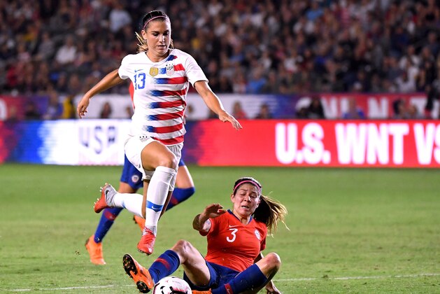 CARSON, CA - AUGUST 31:  Alex Morgan #13 of United States jumps over the slide of Carla Guerrero #3 of Chile as she chases the ball during the first half at StubHub Center on August 31, 2018 in Carson, California.  (Photo by Harry How/Getty Images)