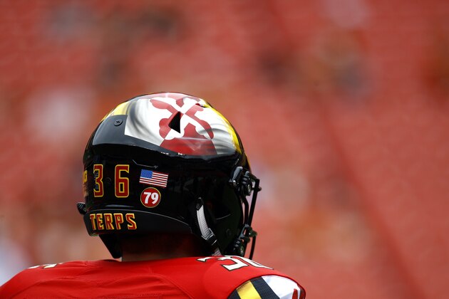 Maryland long snapper Matt Oliveira wears a helmet bearing a sticker in remembrance of offensive lineman Jordan McNair (79), who died after collapsing on a practice field during a spring practice, before an NCAA college football game against Texas, Saturday, Sept. 1, 2018, in Landover, Md. (AP Photo/Patrick Semansky)
