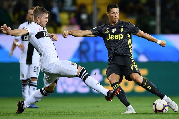 Parma's Italian defender Riccardo Gagliolo (L) vies with Juventus' Portuguese forward Cristiano Ronaldo during the Italian Serie A football match Parma vs Juventus on September 1, 2018 at Ennio Tardini stadium in Parma. (Photo by Marco BERTORELLO / AFP)        (Photo credit should read MARCO BERTORELLO/AFP/Getty Images)