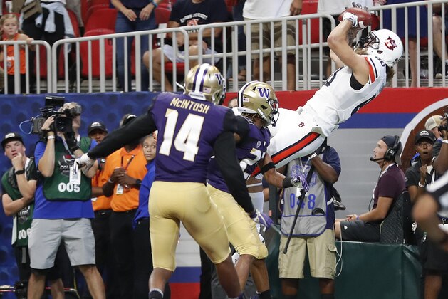 Auburn tight end Sal Cannella (80) makes a catch for a touchdown as Washington defensive backs Jordan Miller (23) and JoJo McIntosh (14) defend in the first half of an NCAA college football game Saturday, Sept. 1, 2018, in Atlanta. (AP Photo/John Bazemore)