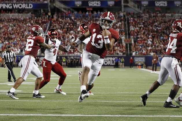 ORLANDO, FL - SEPTEMBER 01: Tua Tagovailoa #13 of the Alabama Crimson Tide runs for a nine-yard touchdown in the first quarter of the game against the Louisville Cardinals at Camping World Stadium on September 1, 2018 in Orlando, Florida. (Photo by Joe Robbins/Getty Images)
