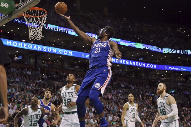 Philadelphia 76ers center Joel Embiid (21) goes to the hoop against Boston Celtics guard Terry Rozier (12), forward Al Horford (42), forward Jayson Tatum (0) and center Aron Baynes (46) in the first quarter of Game 2 of an NBA basketball second-round playoff series, Thursday, May 3, 2018, in Boston. (AP Photo/Elise Amendola)