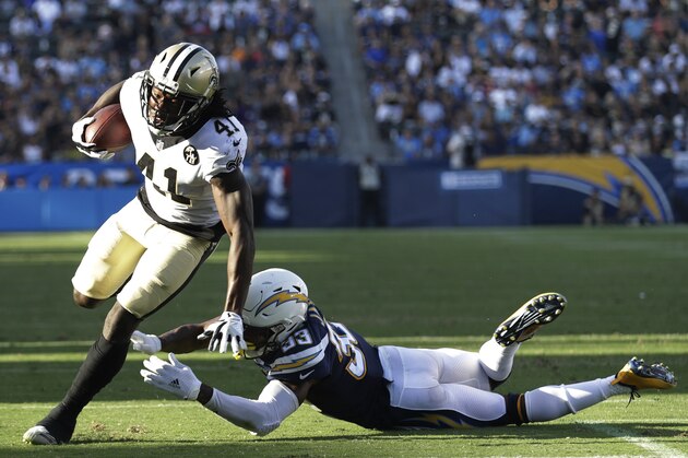 New Orleans Saints running back Alvin Kamara gets away from Los Angeles Chargers defensive back Derwin James during the first half of an NFL preseason football game Saturday, Aug. 25, 2018, in Carson, Calif. (AP Photo/Marcio Jose Sanchez)