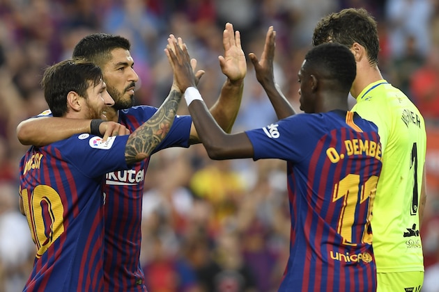 Barcelona's Argentinian forward Lionel Messi (L) celebrates with teammates scoring his team's sixth goal with Barcelona's Uruguayan forward Luis Suarez during the Spanish league football match between FC Barcelona and SD Huesca at the Camp Nou stadium in Barcelona on September 2, 2018. (Photo by LLUIS GENE / AFP)        (Photo credit should read LLUIS GENE/AFP/Getty Images)