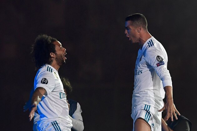 Real Madrid's Brazilian defender Marcelo (L) and Real Madrid's Portuguese forward Cristiano Ronaldo celebrate at the Santiago Bernabeu stadium in Madrid on May 27, 2018 during a victory ceremony after Real Madrid won its third Champions League title in a row in Kiev. (Photo by OSCAR DEL POZO / AFP)        (Photo credit should read OSCAR DEL POZO/AFP/Getty Images)