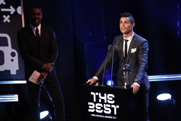 LONDON, ENGLAND - OCTOBER 23:  Cristiano Ronaldo of Portugal and Real Madrid CF wins The best Fifa men's player as Idris Elba looks on during The Best FIFA Football Awards Show on October 23, 2017 in London, England.  (Photo by Bryn Lennon/Getty Images)