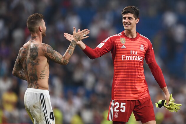 MADRID, SPAIN - SEPTEMBER 01:  Thibaut Courtois of Real Madrid is congratulated by teammate Sergio Ramos  after playing his first La Liga match during the La Liga match between Real Madrid CF and CD Leganes at Estadio Santiago Bernabeu on September 1, 2018 in Madrid, Spain. (Photo by Denis Doyle/Getty Images)