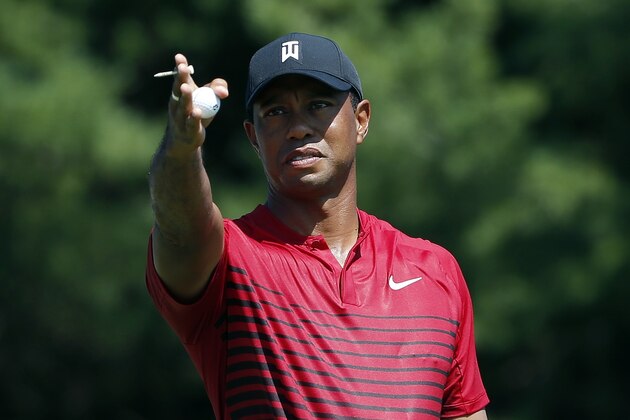 Tiger Woods indicates the direction of the wind before teeing off on the third hole during the final round of the Dell Technologies Championship golf tournament at TPC Boston in Norton, Mass., Monday, Sept. 3, 2018. (AP Photo/Michael Dwyer)