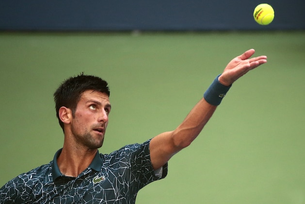 Novak Djokovic, of Serbia, serves to Joao Sousa, of Portugal, during the fourth round of the U.S. Open tennis tournament, Monday, Sept. 3, 2018, in New York. (AP Photo/Andres Kudacki)